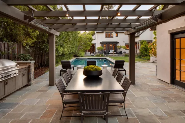 a dining room with furniture and a floor to ceiling window