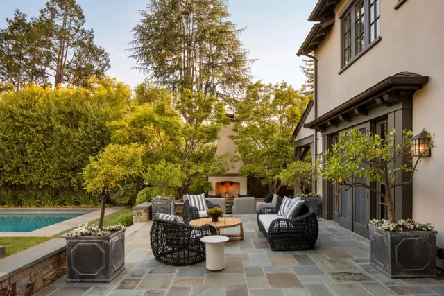 a backyard of a house with table and chairs