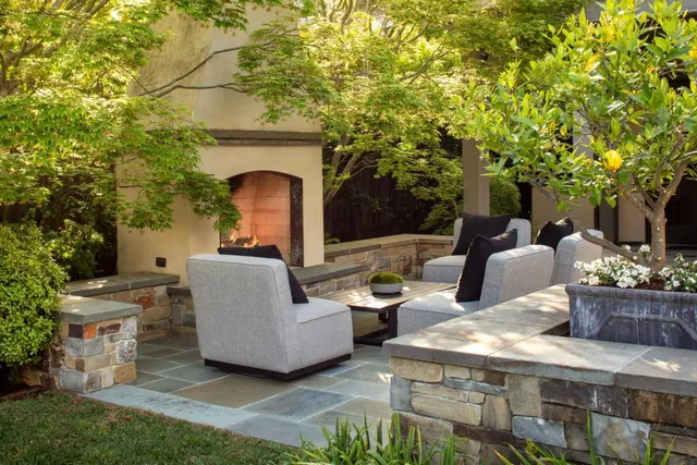 a view of a patio with couches table and chairs and potted plants