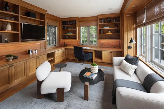 a living room with furniture a rug and a flat screen tv