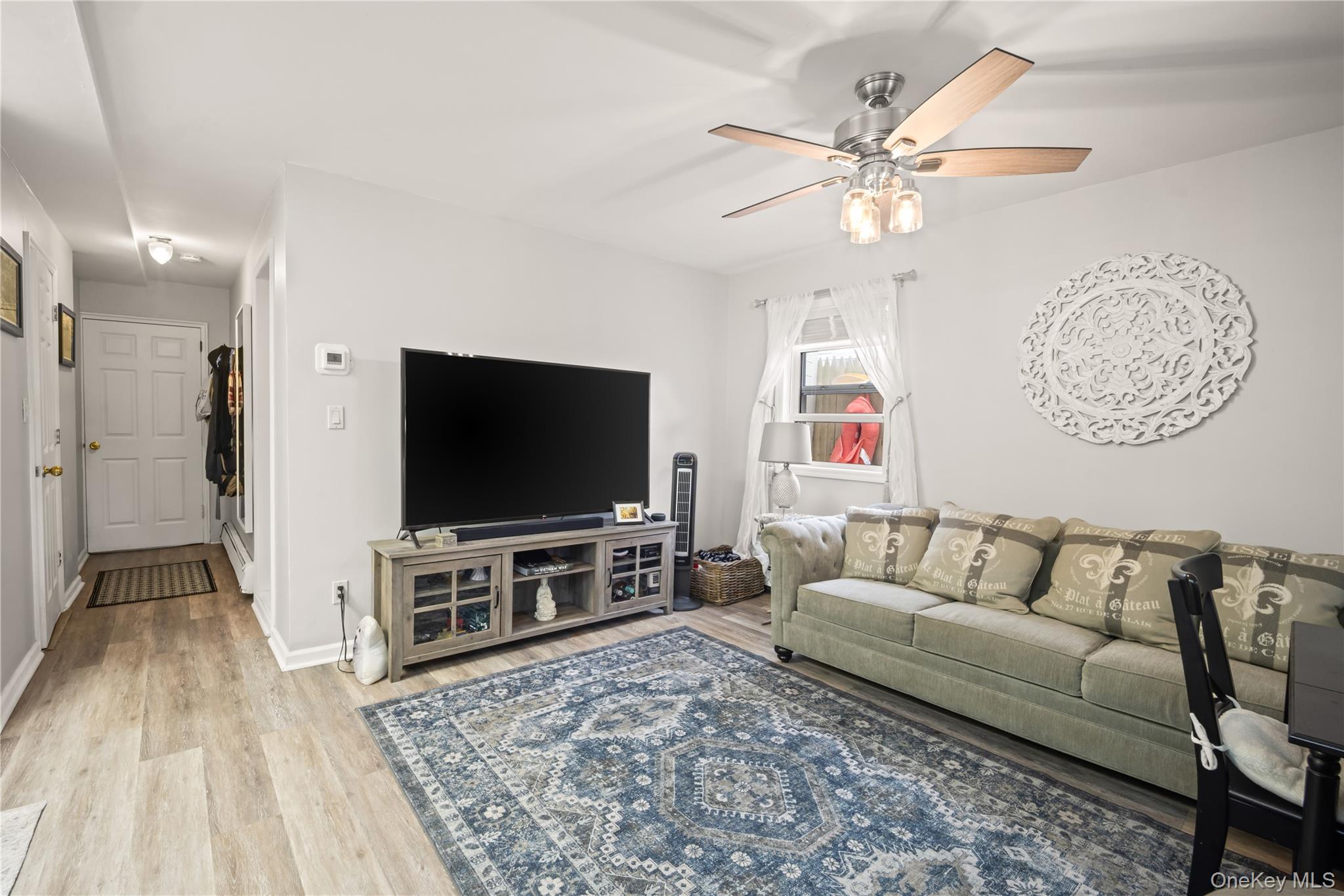 98 Hawkins Street Bronx, NY 10464 - Photo 17 of 26 a living room with furniture and a flat screen tv