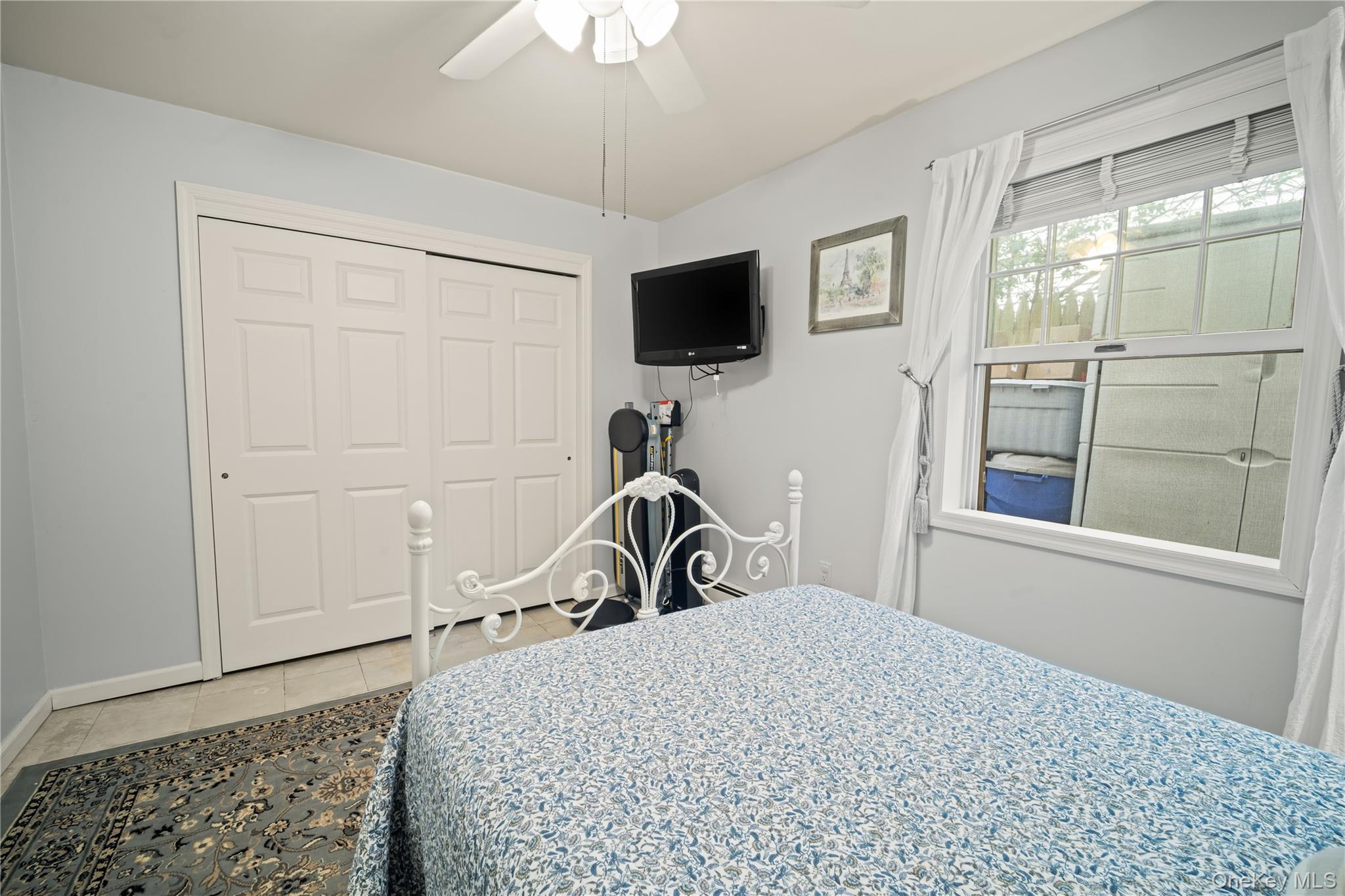 98 Hawkins Street Bronx, NY 10464 - Photo 19 of 26 a bedroom with a bed and a flat tv screen on the dresser