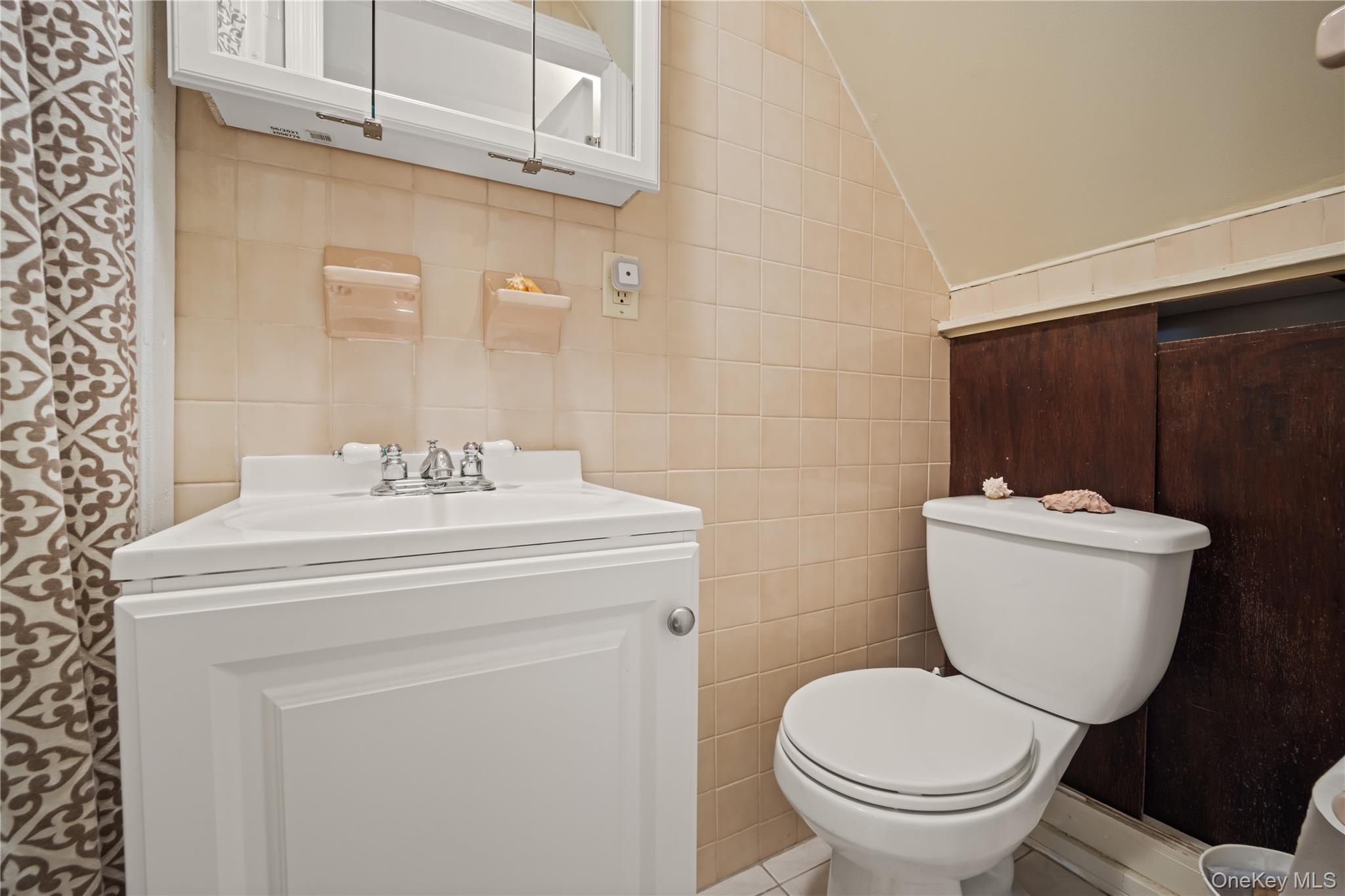 98 Hawkins Street Bronx, NY 10464 - Photo 20 of 26 a bathroom with a sink toilet and a mirror