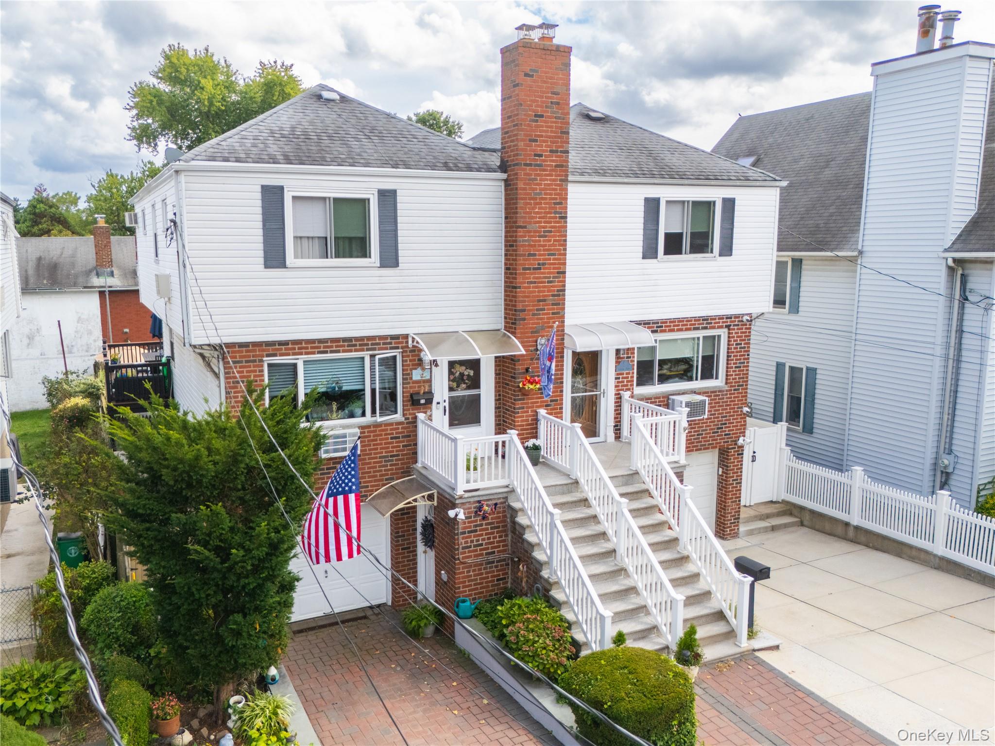 98 Hawkins Street Bronx, NY 10464 - Photo 2 of 26 a front view of a house with garden and plants