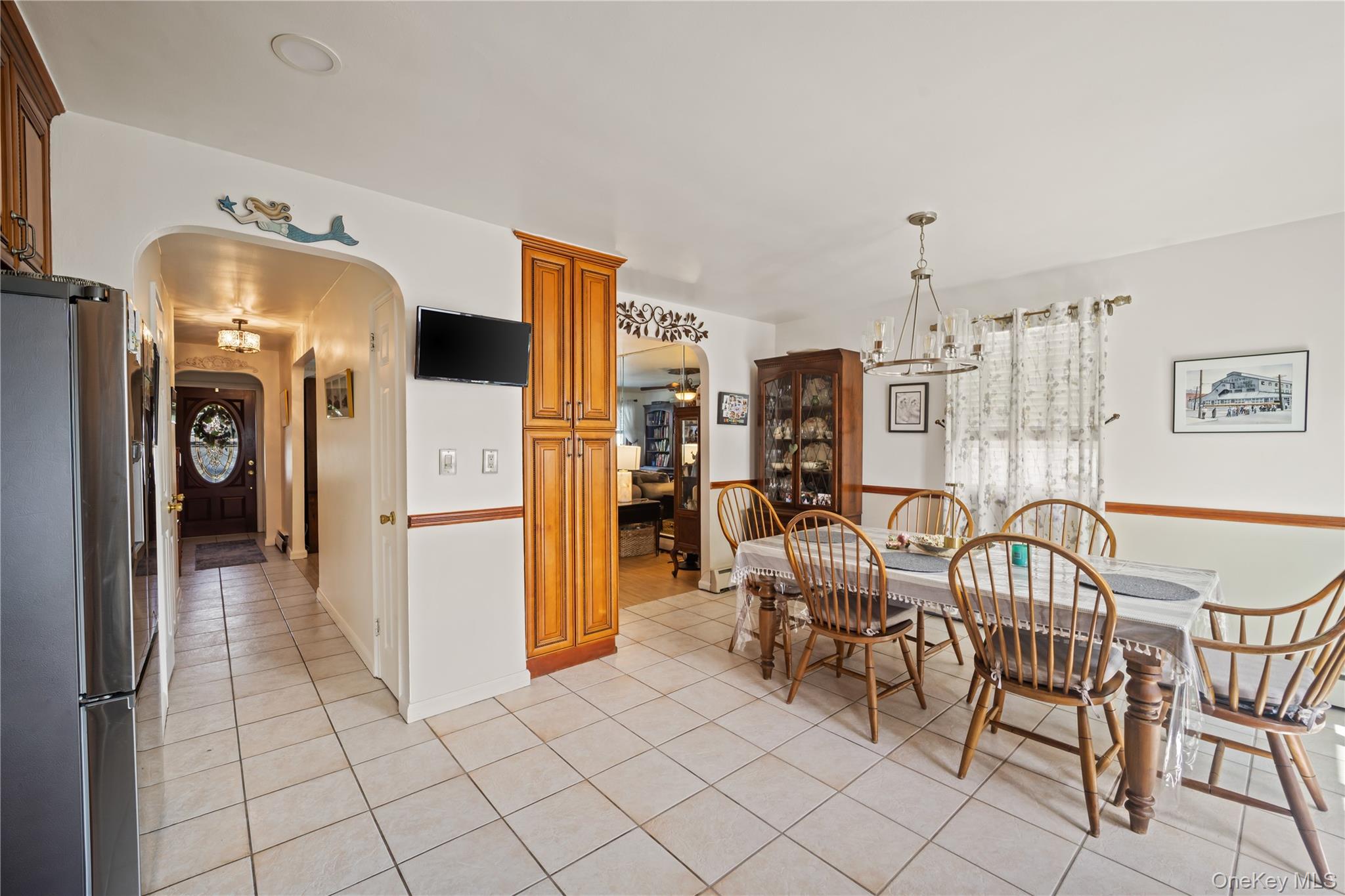 98 Hawkins Street Bronx, NY 10464 - Photo 3 of 26 a dining room with furniture and a refrigerator