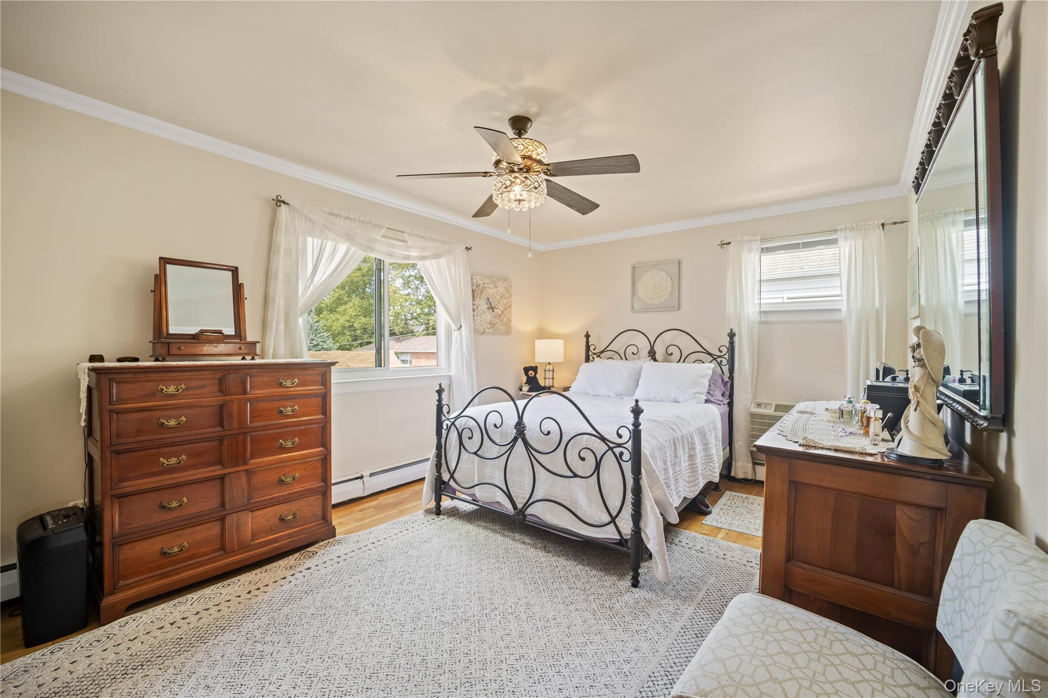 98 Hawkins Street Bronx, NY 10464 - Photo 8 of 26 a bedroom with a bed and a dresser with the mirror