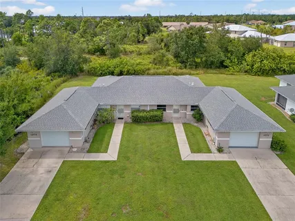 an aerial view of a house with pool