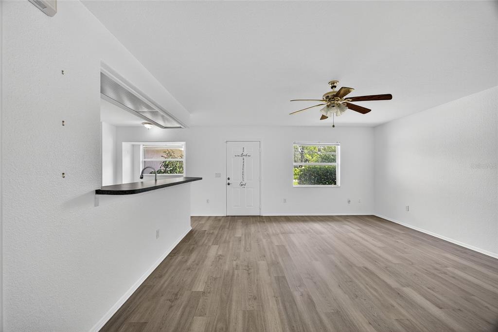 1071 Nomad Road Punta Gorda, FL 33983 - Photo 5 of 22 wooden floor in an empty room with a window