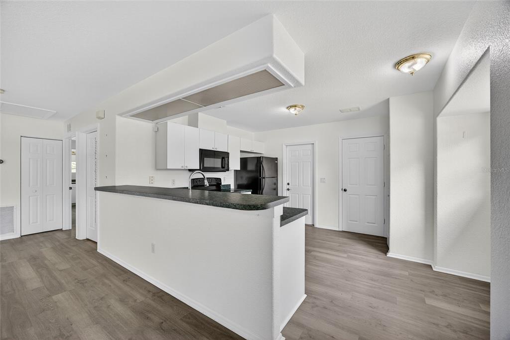 1071 Nomad Road Punta Gorda, FL 33983 - Photo 6 of 22 a kitchen with stainless steel appliances granite countertop a refrigerator and a stove top oven