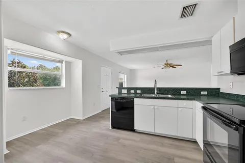 a kitchen with stainless steel appliances granite countertop a stove and a sink