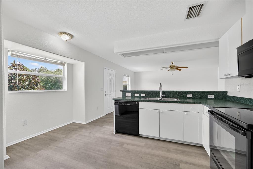 1071 Nomad Road Punta Gorda, FL 33983 - Photo 8 of 22 a kitchen with stainless steel appliances granite countertop a stove and a sink