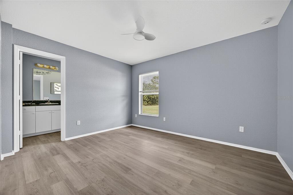 1071 Nomad Road Punta Gorda, FL 33983 - Photo 10 of 22 a view of an empty room with wooden floor and a window
