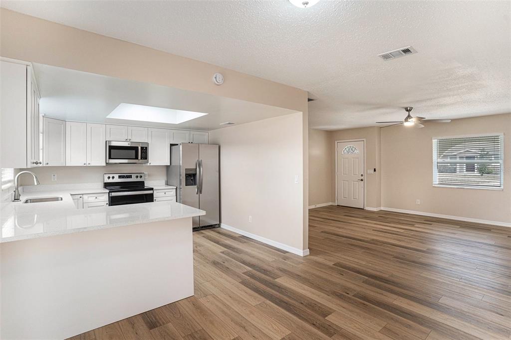 2527 Ridge Top Way Valrico, FL 33594 - Photo 8 of 29 a kitchen with granite countertop a refrigerator stove top oven and sink