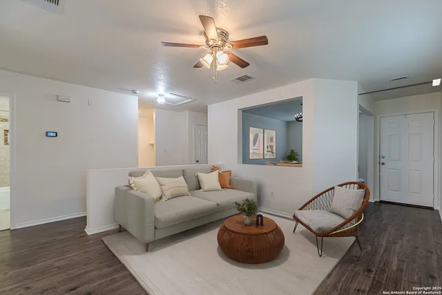 a living room with furniture and a wooden floor