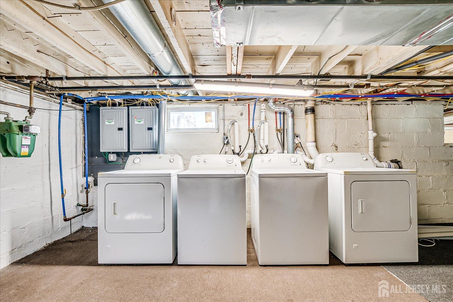 385 Pierson Avenue, Unit 1 Edison, NJ 08837 - Photo 14 of 17 a room with cabinets and washer dryer