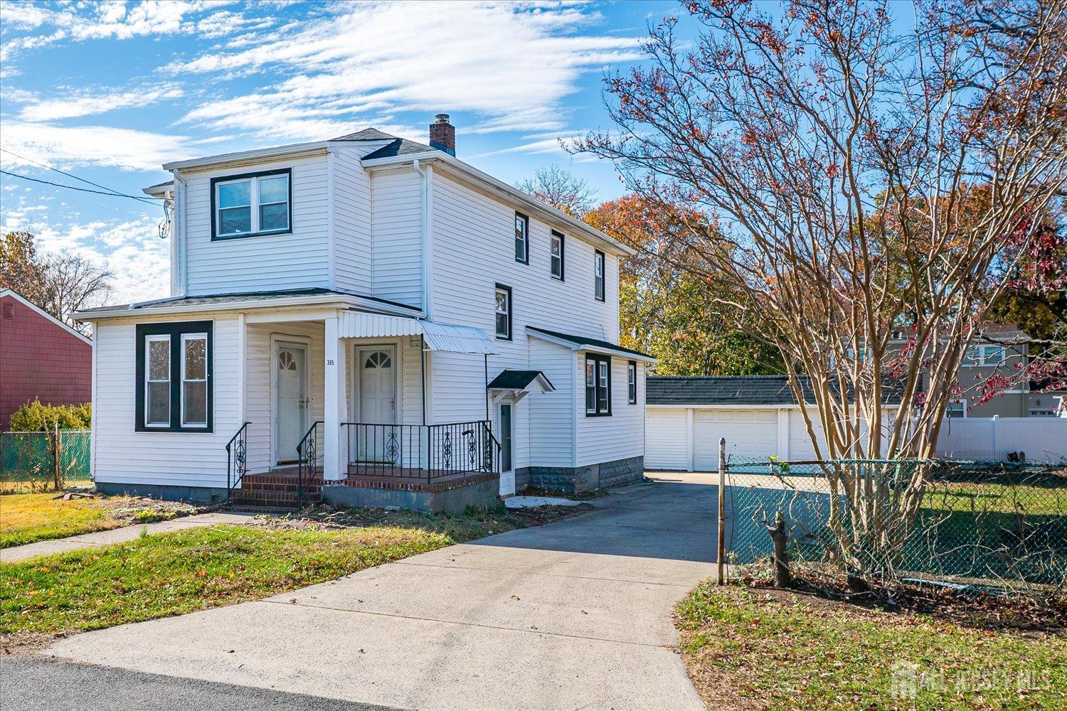 385 Pierson Avenue, Unit 1 Edison, NJ 08837 - Photo 3 of 17 a front view of a house with a yard and garage