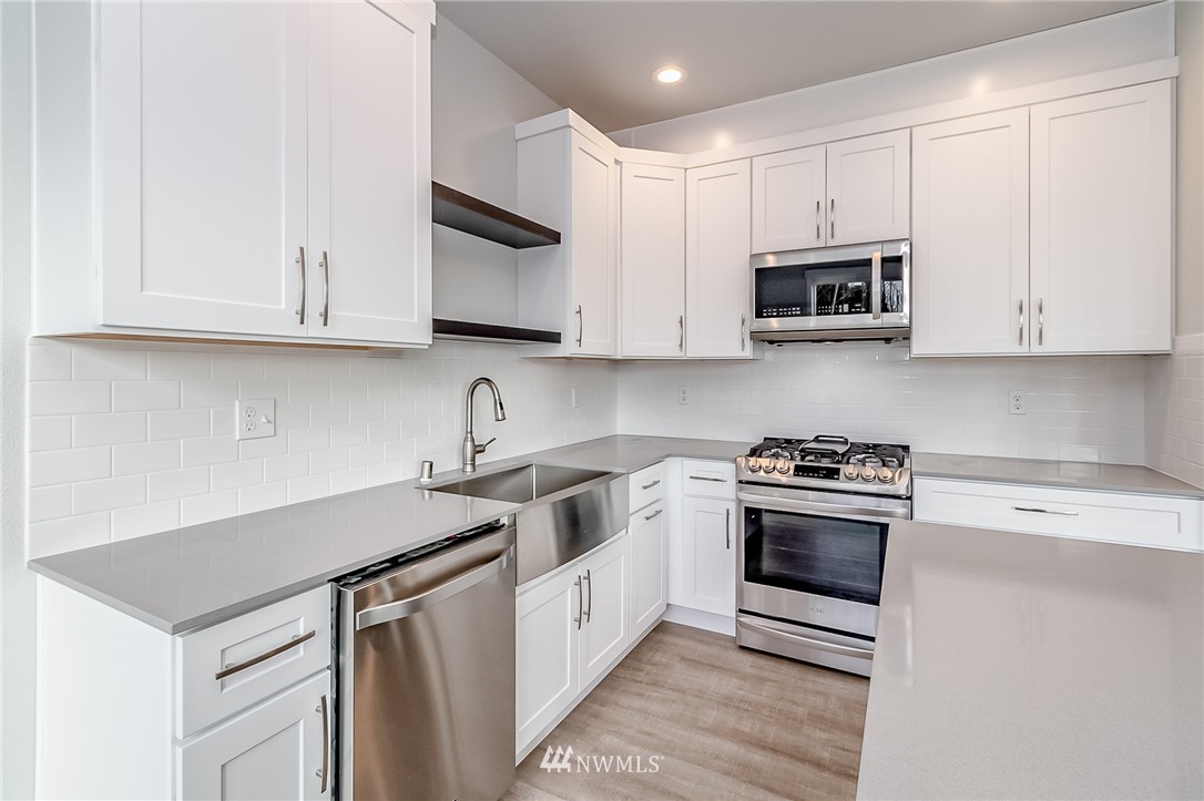 2720 Callow Road, Unit A Lake Stevens, WA 98258 - Photo 13 of 32 a kitchen with stainless steel appliances granite countertop a sink stove and microwave