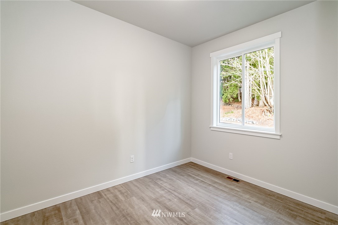 2720 Callow Road, Unit A Lake Stevens, WA 98258 - Photo 17 of 32 an empty room with wooden floor and windows