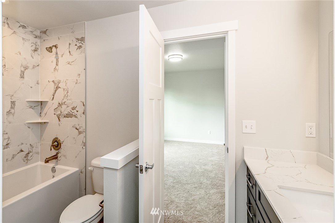 2720 Callow Road, Unit A Lake Stevens, WA 98258 - Photo 23 of 32 a bathroom with a granite countertop bathtub shower sink vanity and toilet
