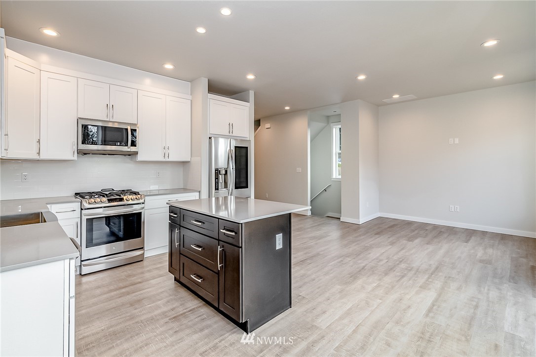 2720 Callow Road, Unit A Lake Stevens, WA 98258 - Photo 8 of 32 a kitchen with stainless steel appliances a stove a sink a microwave a refrigerator and cabinets