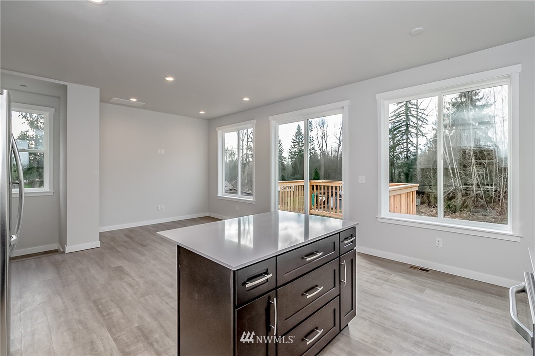 2720 Callow Road, Unit A Lake Stevens, WA 98258 - Photo 10 of 32 an empty room with wooden floor and windows