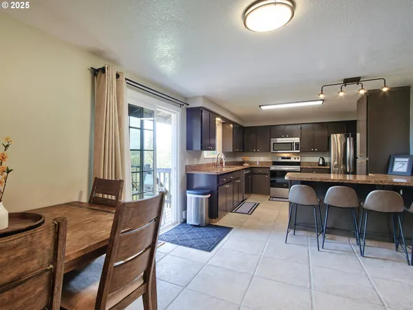 a living room with furniture and kitchen view
