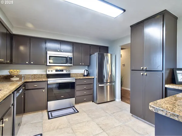 a kitchen with granite countertop cabinets and stainless steel appliances