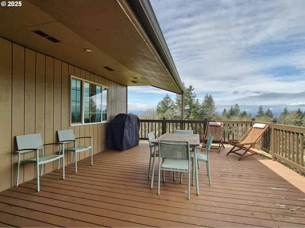 a view of a balcony with wooden floor and outdoor seating