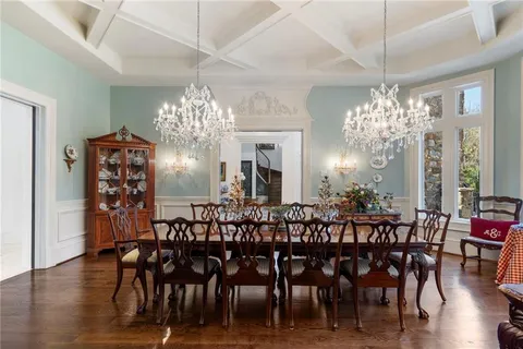a view of a dining room with furniture large windows and wooden floor