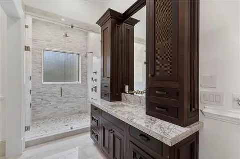 a spacious bathroom with a granite countertop sink a toilet and bathtub