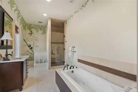 a spacious bathroom with a bathtub a shower a sink and a window