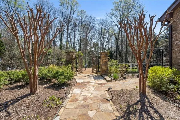a kitchen with stainless steel appliances granite countertop a table chairs stove and refrigerator
