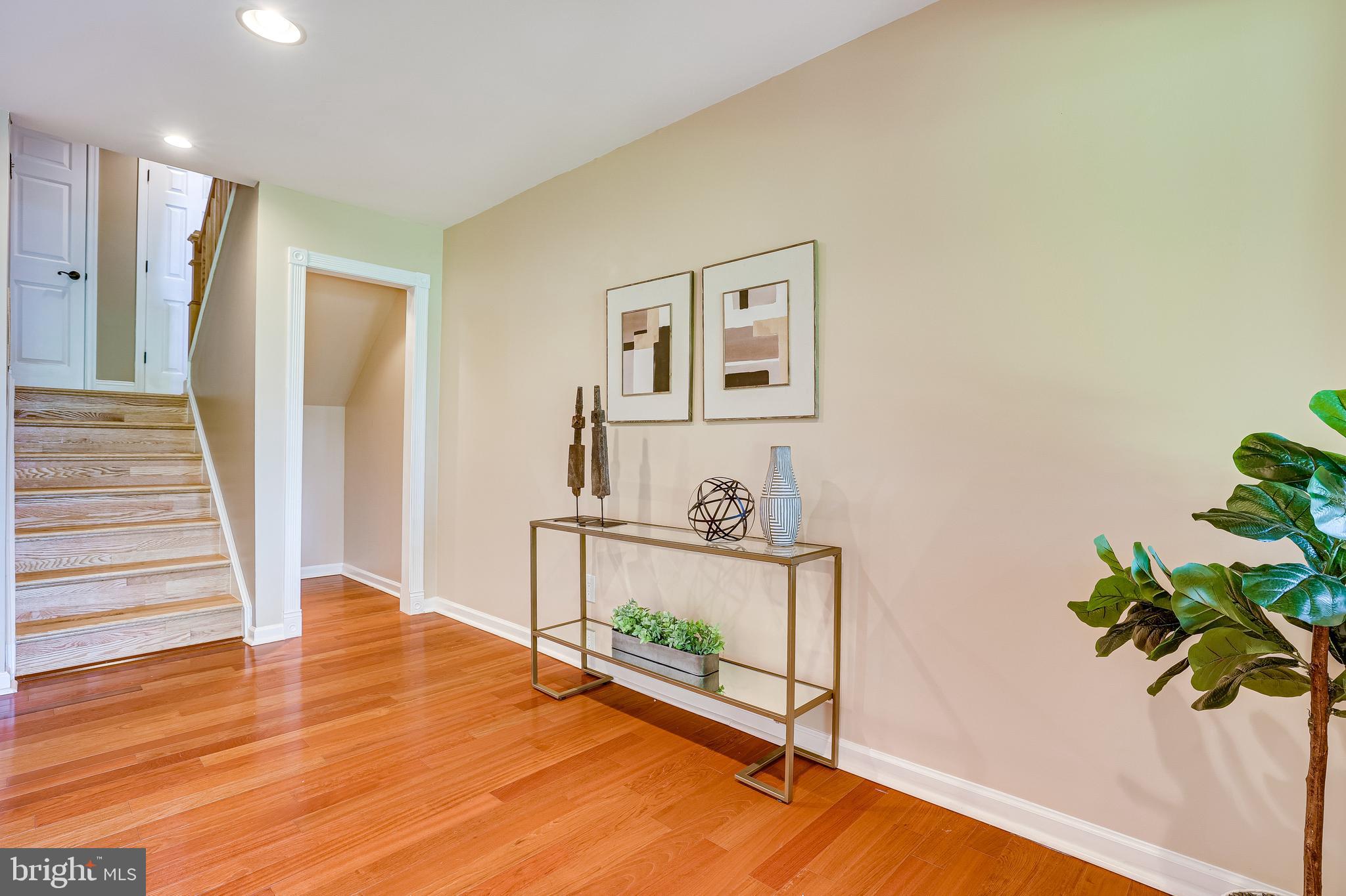 11056 Thrush Ridge Road Reston, VA 20191 - Photo 49 of 62 a living room with wooden floor and potted plant