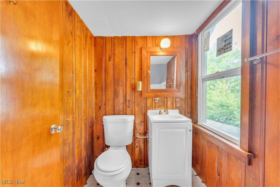 913 Helmsdale Road, Unit 3 Cleveland, OH 44112 - Photo 14 of 19 Bathroom featuring wood walls, vanity, and tile patterned flooring