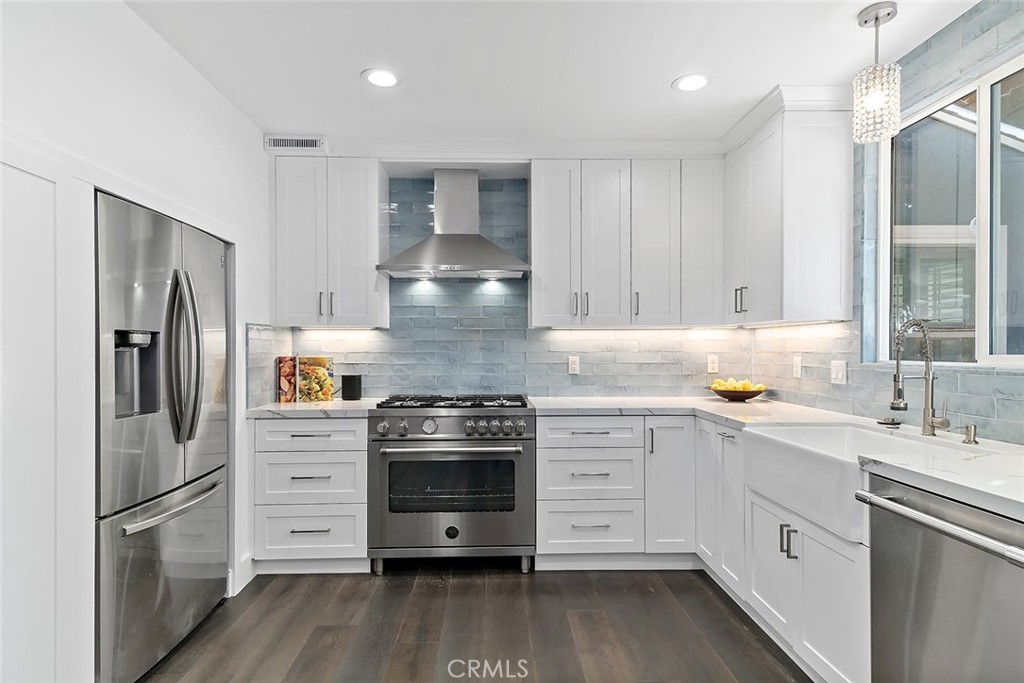 5733 2nd Street Long Beach, CA 90803 - Photo 8 of 32 a kitchen with stainless steel appliances a stove sink and refrigerator