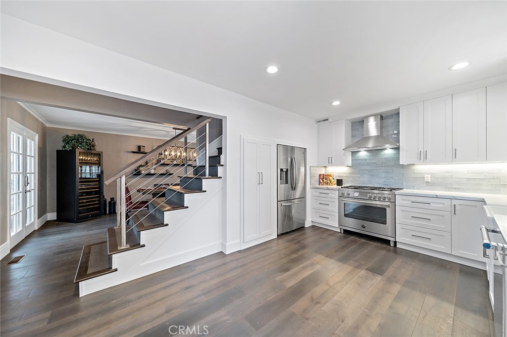 5733 2nd Street Long Beach, CA 90803 - Photo 9 of 32 a kitchen with white cabinets and appliances