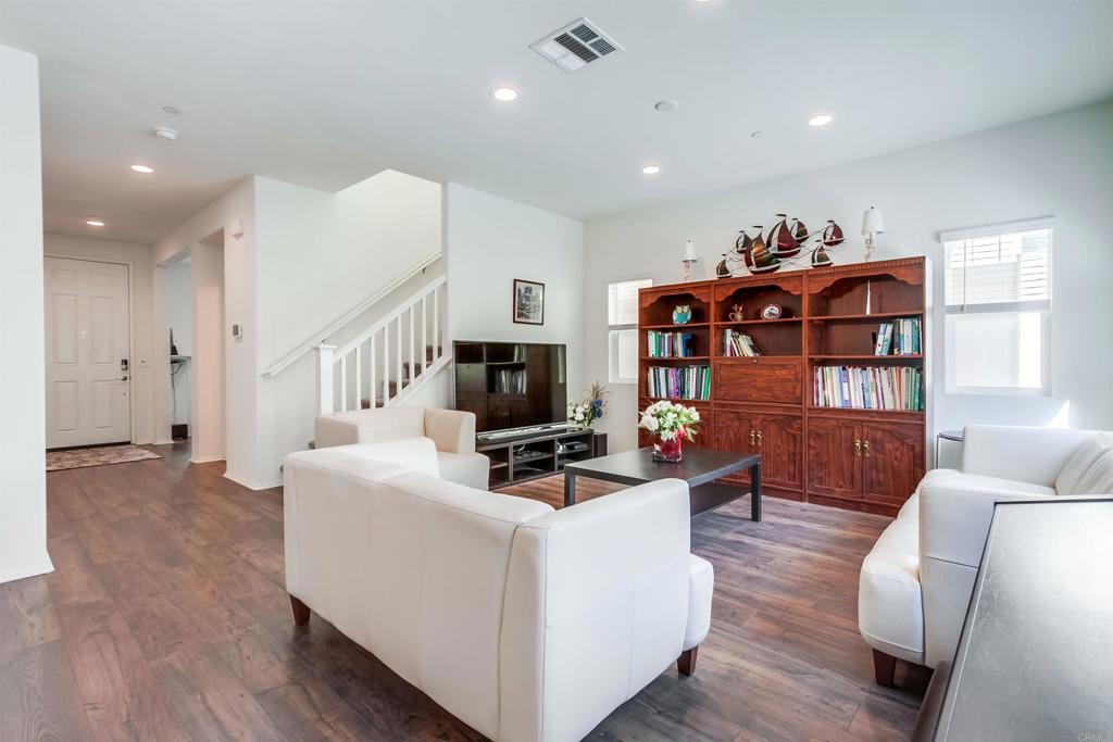 235 Spotted Saddle Way Fallbrook, CA 92028 - Photo 11 of 71 a living room with furniture a flat screen tv and a fireplace