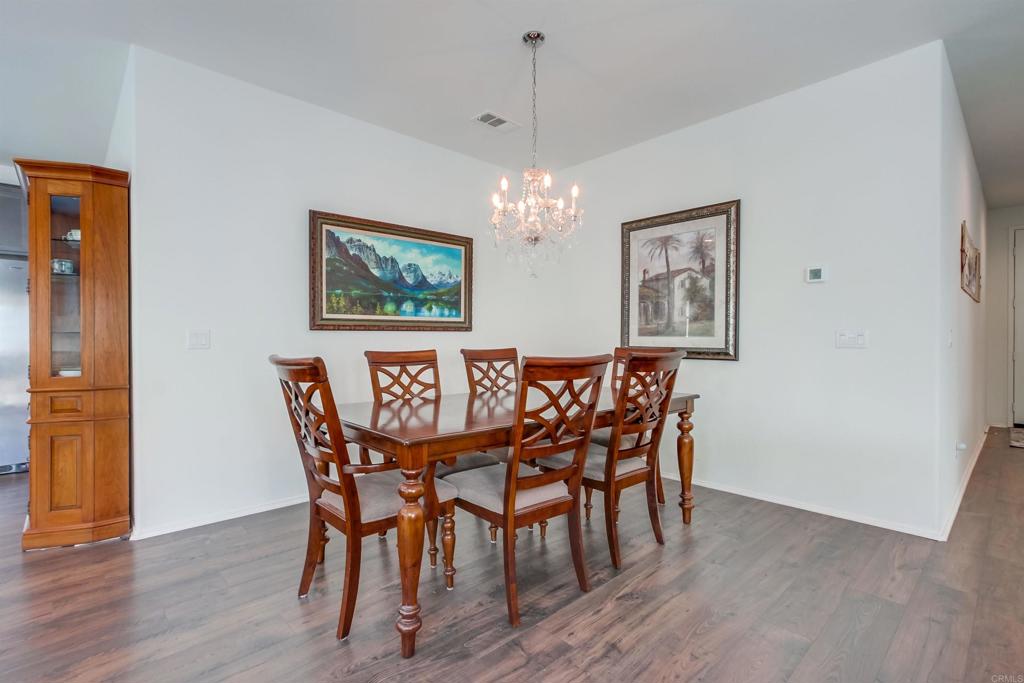 235 Spotted Saddle Way Fallbrook, CA 92028 - Photo 16 of 71 a view of a dining room with furniture wooden floor and a chandelier