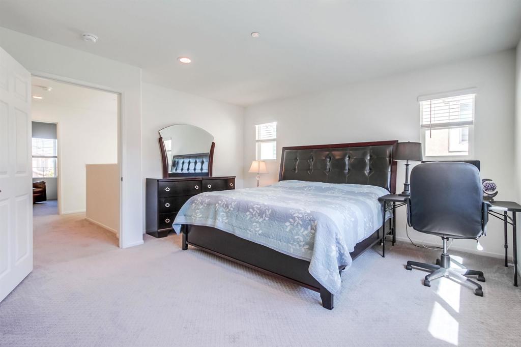 235 Spotted Saddle Way Fallbrook, CA 92028 - Photo 27 of 71 a bedroom with a bed lamps and chairs
