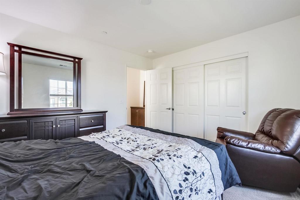 235 Spotted Saddle Way Fallbrook, CA 92028 - Photo 36 of 71 a bedroom with a large bed and a window