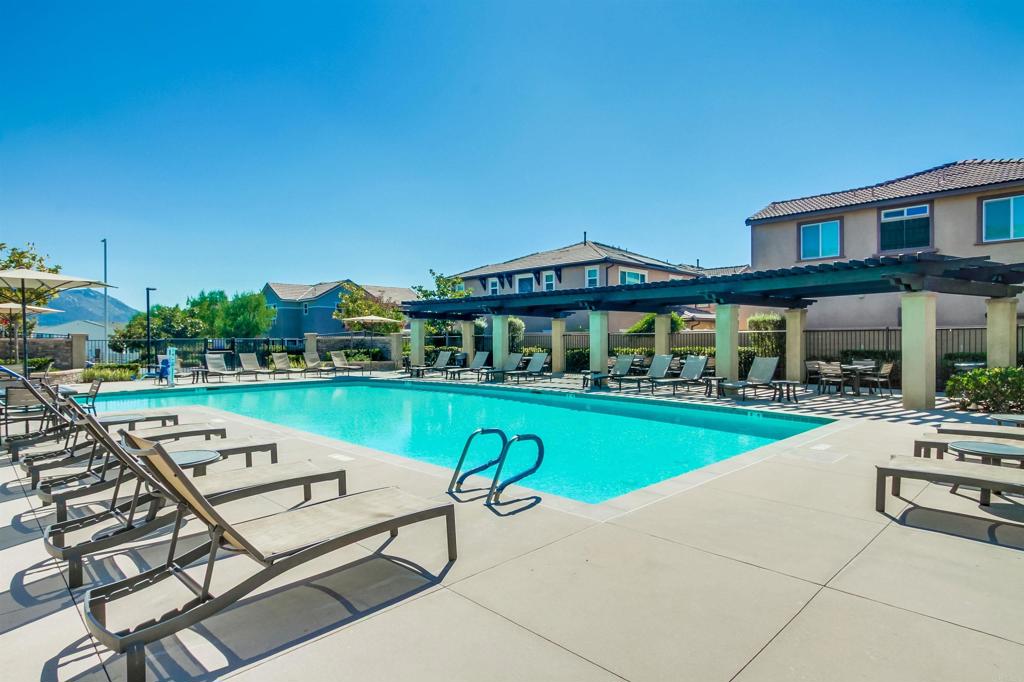 235 Spotted Saddle Way Fallbrook, CA 92028 - Photo 51 of 71 a view of a house with pool lawn chairs and a yard