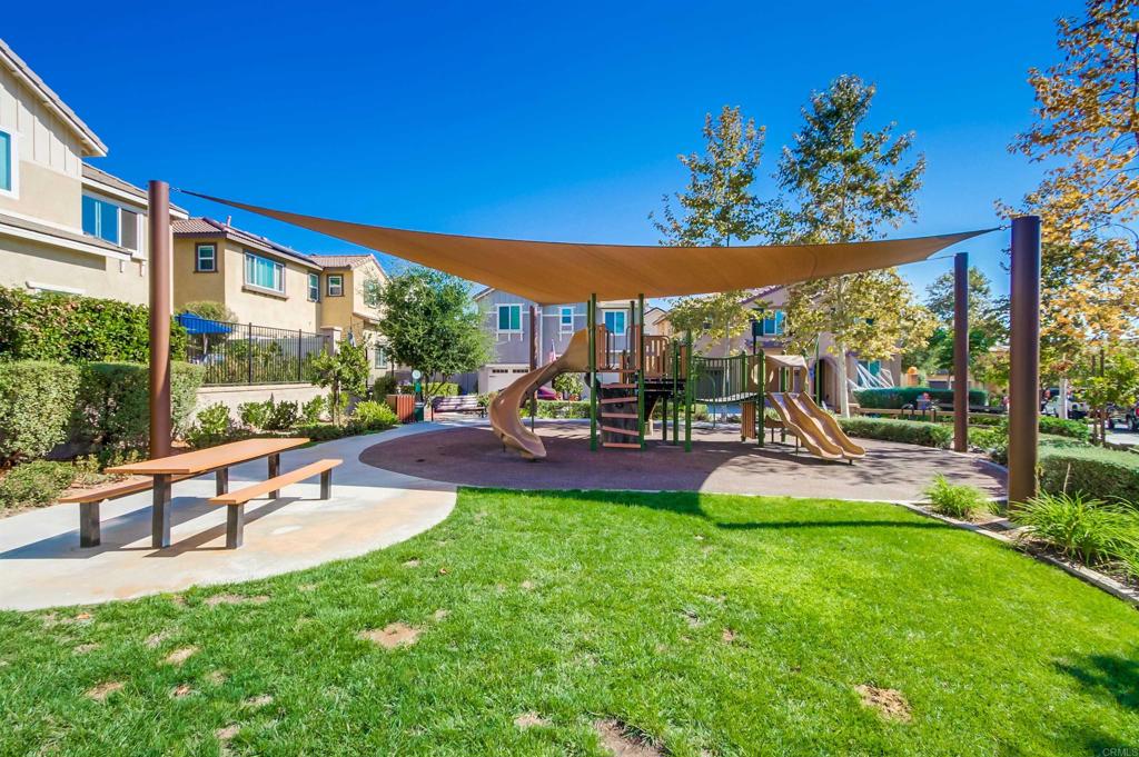 235 Spotted Saddle Way Fallbrook, CA 92028 - Photo 71 of 71 a view of a patio with table and chairs potted plants with wooden floor and fence
