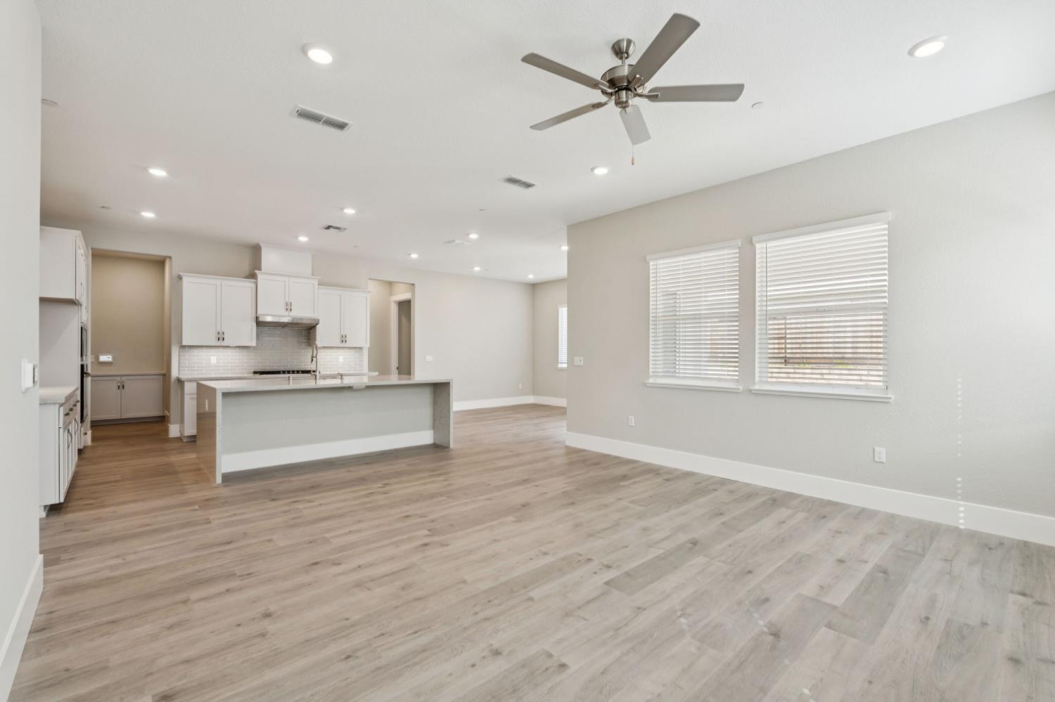 3031 Pocosol Way Rancho Cordova, CA 95742 - Photo 14 of 47 a view of kitchen with kitchen island wooden floor center island and stainless steel appliances