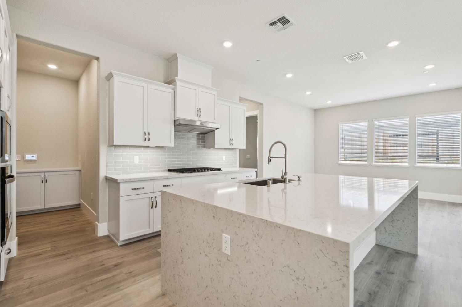 3031 Pocosol Way Rancho Cordova, CA 95742 - Photo 19 of 47 a large kitchen with stainless steel appliances granite countertop a lot of counter space and wooden floors