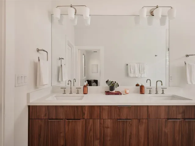 a bathroom with a double vanity sink and a mirror