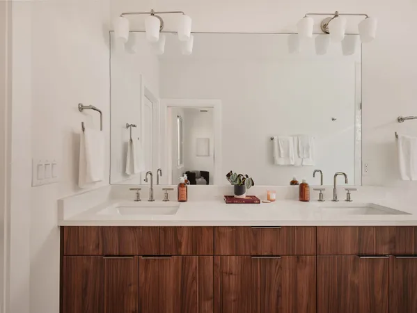 a bathroom with a double vanity sink and a mirror