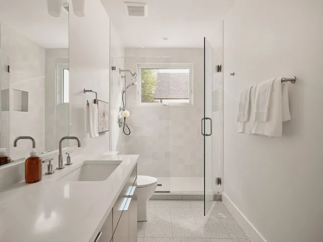a bathroom with a tub sink and mirror