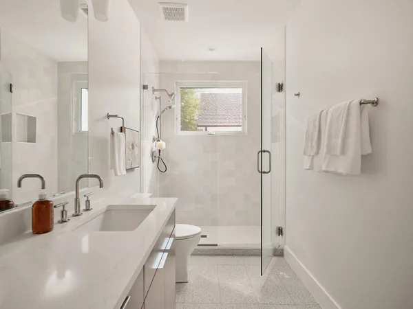 a bathroom with a tub sink and mirror