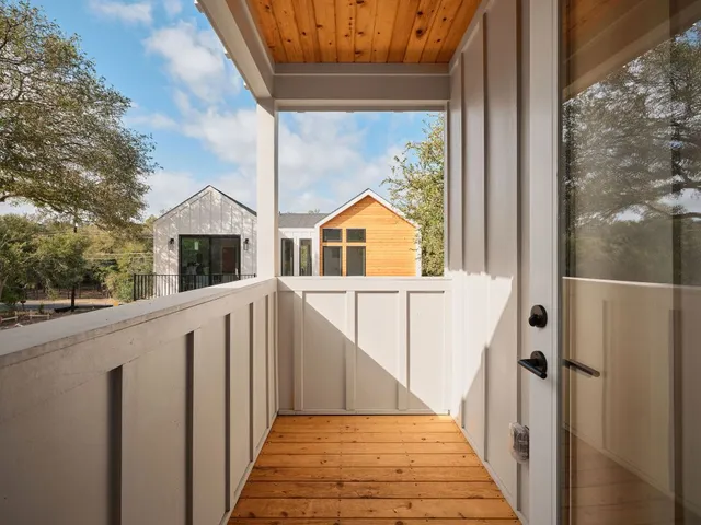a view of a house with wooden fence