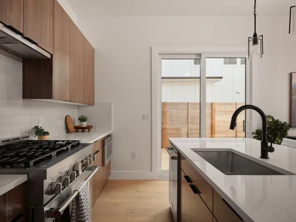 a kitchen that has a sink and a stove